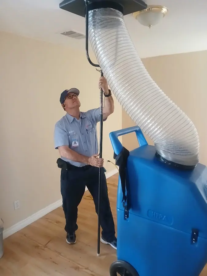 Furnace Tune-Up technician using HEPA equipment in Louisville